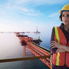 Female oil rig foreman standing with her arms crossed